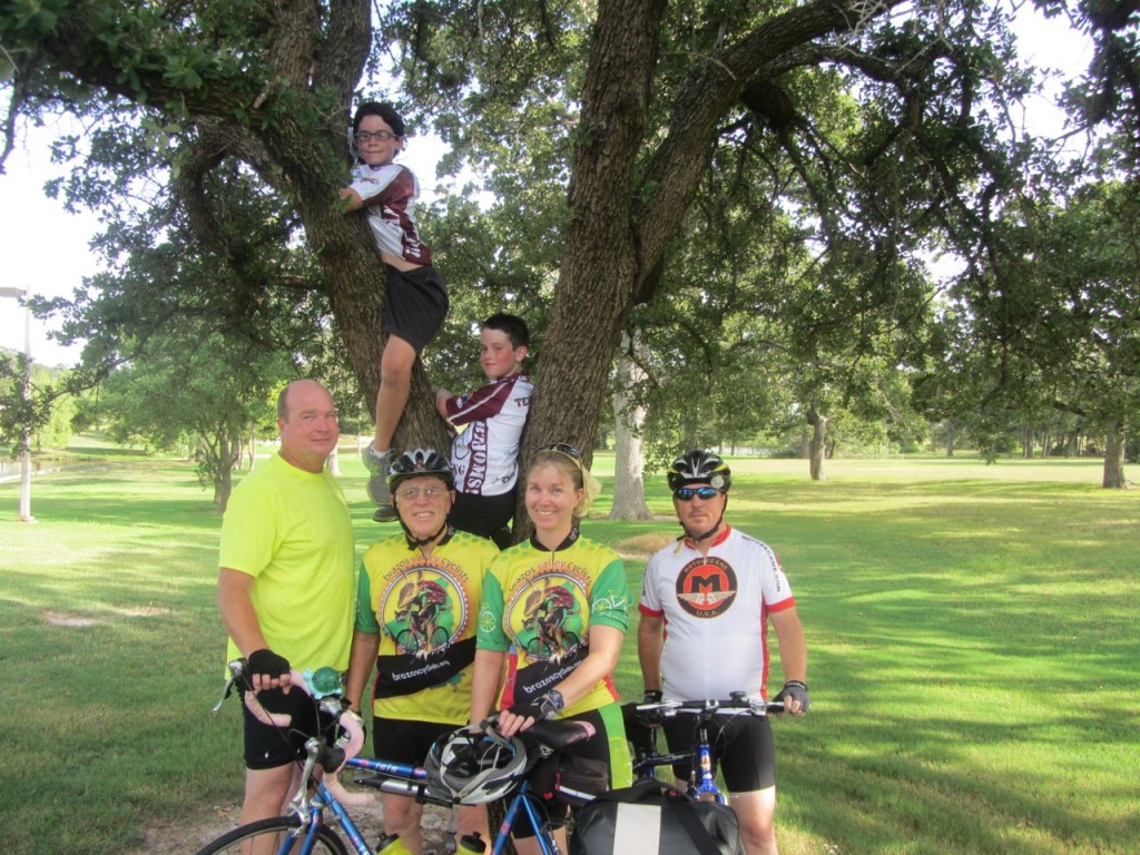 Social Ride crew with two boys in a tree.